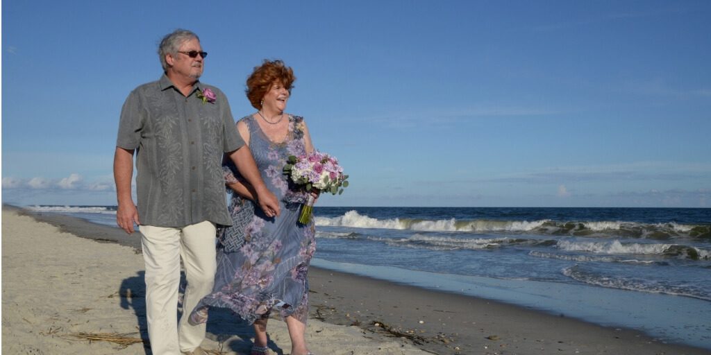 Daniel and Louise walk on the beach on their wedding day. True love has come full circle 45 years later.